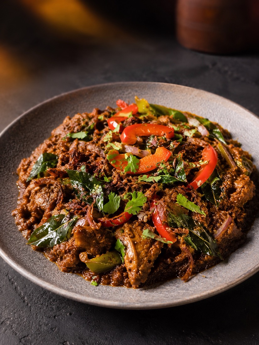 Baingan bartha topped with capsicum and curry leaves