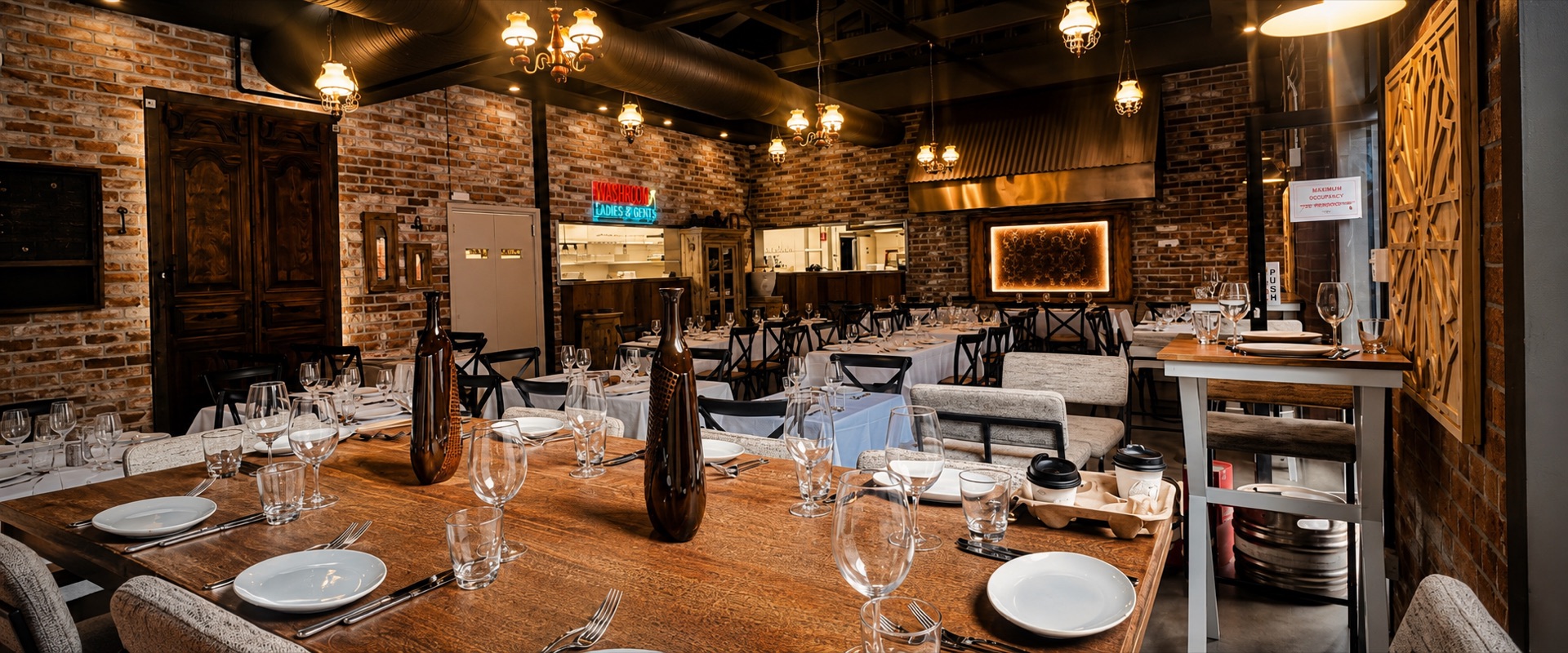 The candlelit dining room: exposed brick, chandeliers and white linen tables