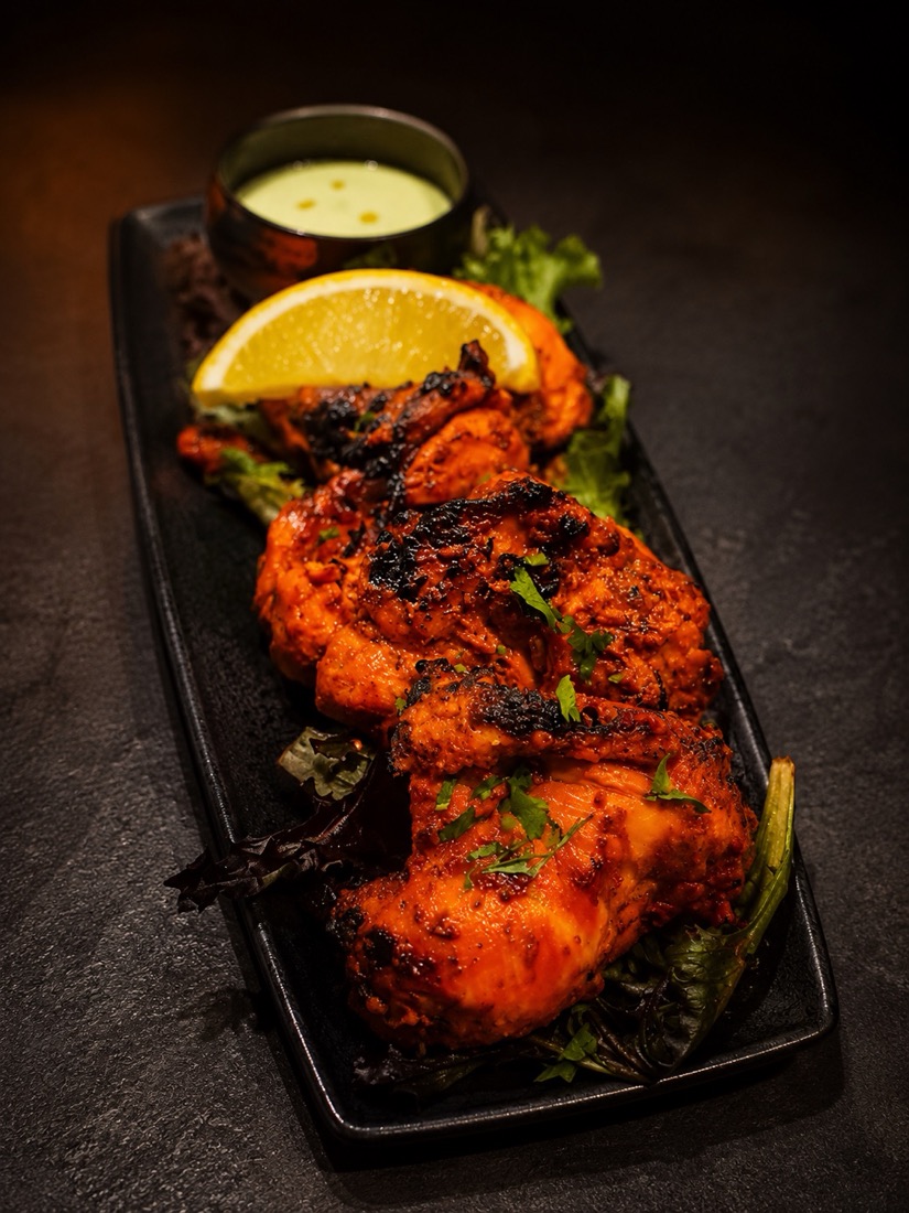 Char-grilled tandoori chicken with mint sauce and lemon